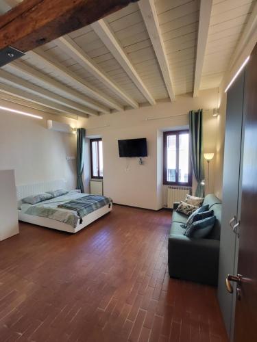 a large room with a bed and a couch at Mono Arnaldo in Brescia