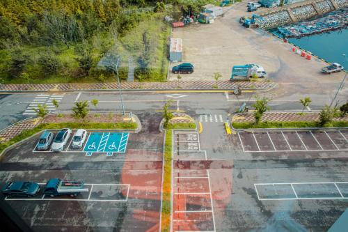 an aerial view of a parking lot with parked cars at Ocean Marina Suite View in Yeosu