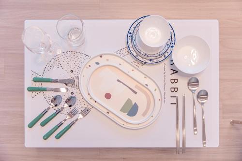 a tray with plates and utensils on a table at Ocean Marina Suite View in Yeosu