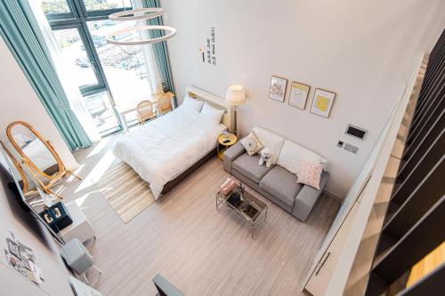 an overhead view of a living room with a couch and a bed at Ocean Marina Suite View in Yeosu