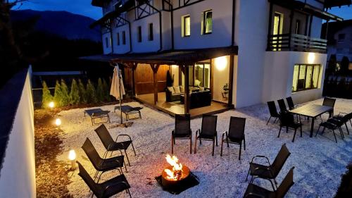 a fire pit in front of a house at night at Jungle Family Villa near Park Aventura,Lake,Zoo in Braşov