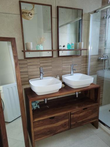 a bathroom with two sinks and a mirror at Ailleurs Land in Carry-le-Rouet
