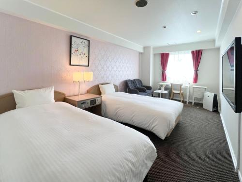 Postel nebo postele na pokoji v ubytování Grand Park Hotel Panex Chiba