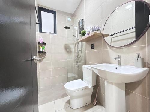 a bathroom with a sink and a toilet and a mirror at Jeff and Ricky Homestay 68 @P Residence in Kuching