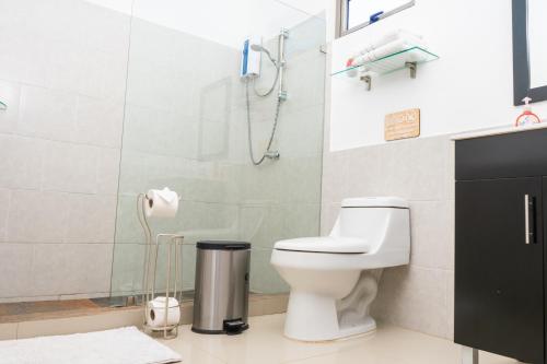 a bathroom with a toilet and a shower at Equinoccio Hotel in Santa Ana