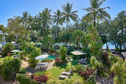 an aerial view of a resort with palm trees and a pool at Pippi at Palm Cove - Melaleuca Private Apartment Palm Cove in Palm Cove