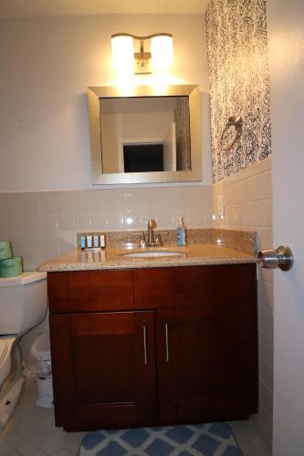 a bathroom with a sink and a mirror at Cheerful Beach Townhouse in Virginia Beach