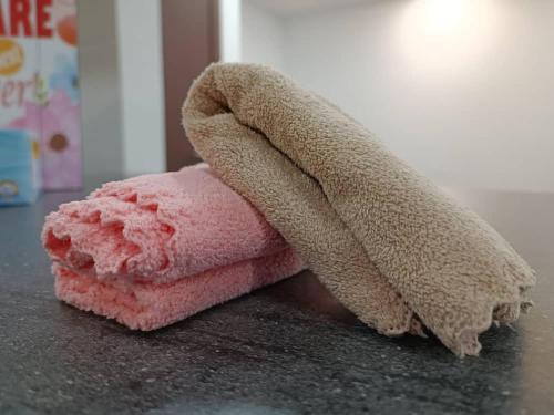 a pink towel sitting on top of a counter at A.Foo Homestay 4.0 @ Vivacity Megamall Jazz Suite 4 in Kuching