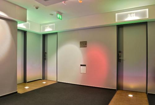 a row of elevator doors in a building at Hotel Santo in Cologne