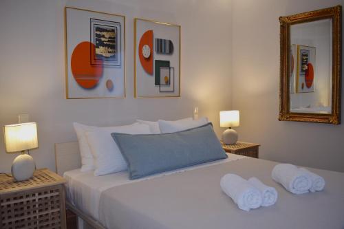 a bedroom with a white bed with towels on it at Ampelos Hillside Villa in Akrata