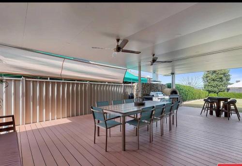 a patio with a table and chairs on a deck at Lakefront Beauty ! Pet friendly in Yarrawonga
