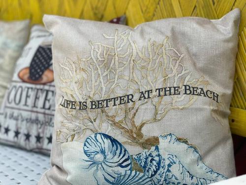 a pillow with the words life is better at the beach at Beachfront Glamping with Mini Pool Exclusive Property in Lingayen