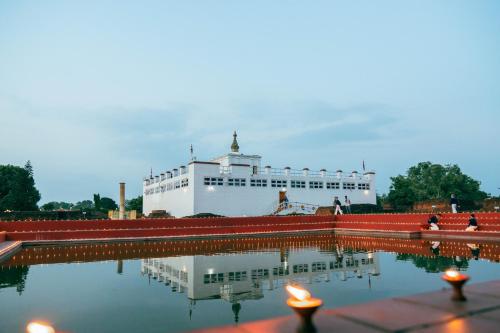 a large boat is parked next to a body of water at Hokke Lumbini in Rummindei