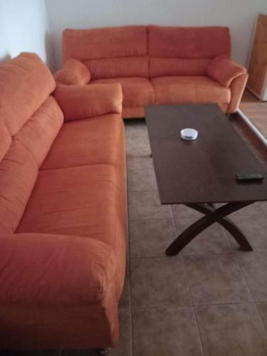 a couch and a coffee table in a living room at Pansion Angela in Skiathos Town