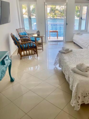 a bedroom with two beds and a view of the ocean at Cavo apartment in Symi