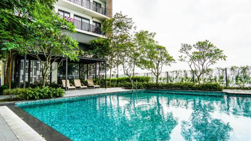 a swimming pool in front of a building at Emporis SOHO Kota Damansara by Airhost in Kota Damansara