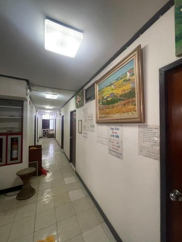 a hallway in a building with a painting on the wall at Residence Inn Pattaya in Pattaya Central