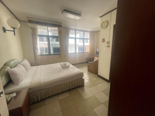 a hotel room with a bed and a window at Residence Inn Pattaya in Pattaya Central