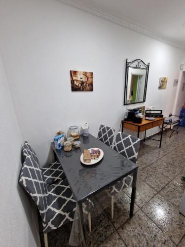 a dining room with a table and chairs and a mirror at Apartment & Beach - Airport in Playa del Burrero