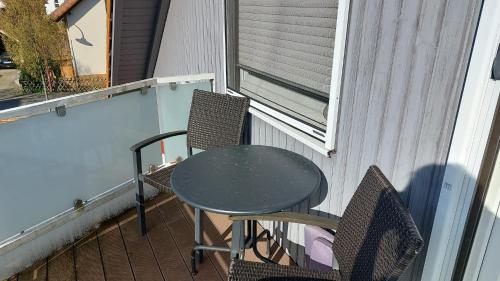 a table and two chairs on a balcony at Gästehaus Yvonne Sigg in Rust