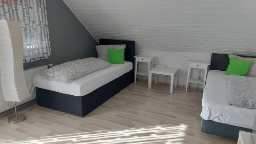 a small bedroom with a bed and two tables at Gästehaus Yvonne Sigg in Rust