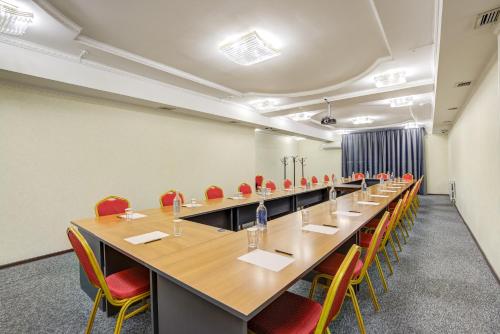 ein großer Konferenzraum mit einem langen Tisch und Stühlen in der Unterkunft Hotel Touristan Bishkek in Bischkek