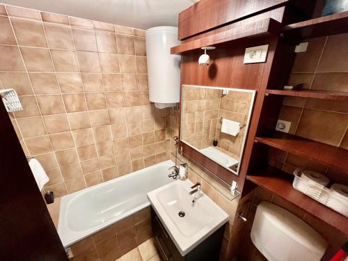 a bathroom with a sink and a tub and a toilet at Apartment TiSa, Bovec in Bovec