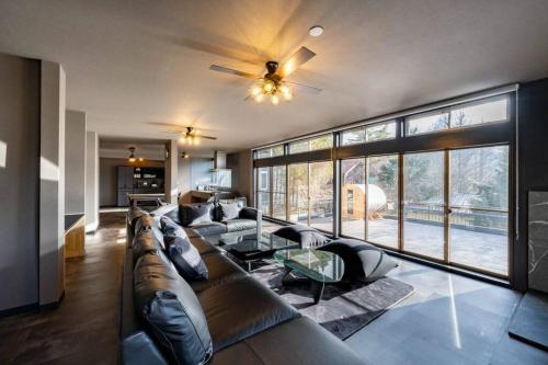 a living room with a couch and a large window at tj resort YAMANAKAKO Luxury large villa with Mt. Fuji, Sauna BBQ Max 25 in Yamanakako