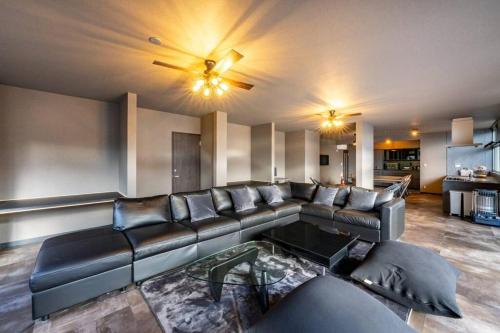 a living room with a couch and a table at tj resort YAMANAKAKO Luxury large villa with Mt. Fuji, Sauna BBQ Max 25 in Yamanakako