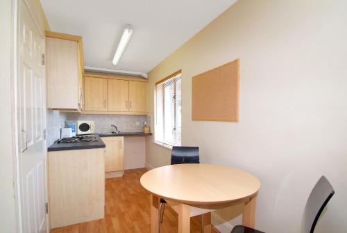 a small kitchen with a table and a small table at Ballyraine Self Catering in Letterkenny