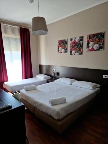 Postel nebo postele na pokoji v ubytování Hotel di Porta Romana