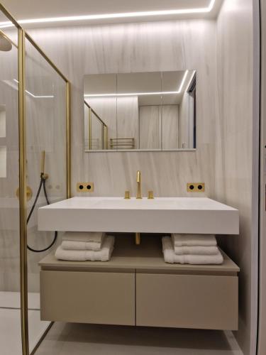 a bathroom with a white sink and a mirror at Luxurious accommodation on the Grand Prix track in Monte Carlo