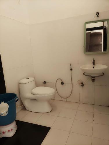 a bathroom with a toilet and a sink at CBC Residency, Karjat in Karjat