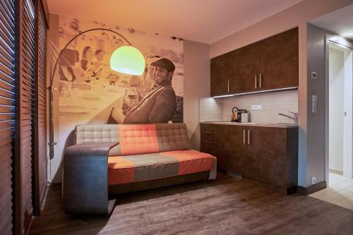 a living room with a couch and a painting on the wall at Hotel GIO in Munich