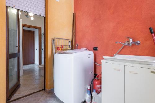 a kitchen with a refrigerator and a sink at Villetta Capitana Vista Mare in Capitana