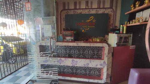a shop with a sign in the window of a store at Superstar Residence Tomohon Redpartner in Tomohon