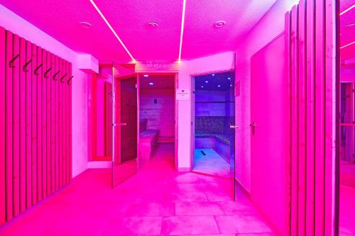 a hallway with pink lights in a room at Das Salzburgblick in Ainring