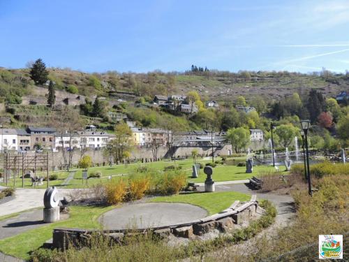 a park on the side of a hill with houses at La cabane d'Achille - La Roche-en-Ardenne in La Roche-en-Ardenne