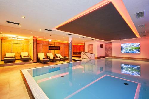 a large swimming pool in the middle of a house at Das Salzburgblick in Ainring