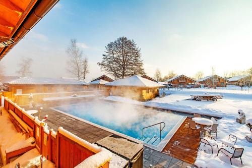 a swimming pool covered in snow next to a house at Das Salzburgblick in Ainring
