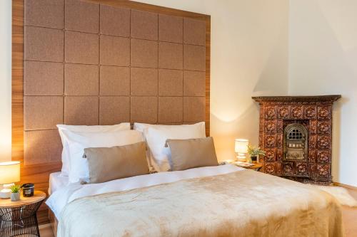 a bedroom with a large bed with two pillows at Primavera - Castle view apartments in Prague
