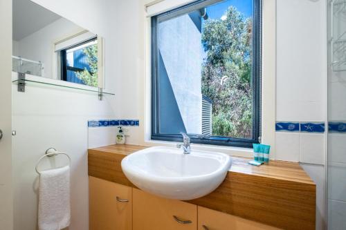 a bathroom with a sink and a large window at Haven on Bradley in Coles Bay
