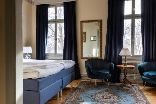 A bed or beds in a room at Park Hotel Linköping Fawlty Towers