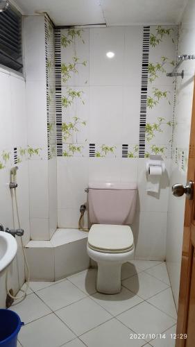 a white bathroom with a toilet and a shower at HOTEL MOHSIN PLAZA in Sreemangal