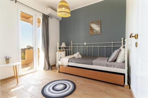 a bedroom with a bed and a large window at Sea View Villa-Luxury Residence-Nature & Calm in Porto Heli