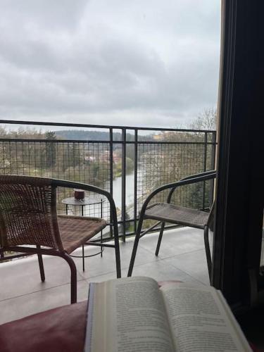 an open book on a balcony with a table and chairs at byt v blízkosti centra a v klidné zóně in Tábor