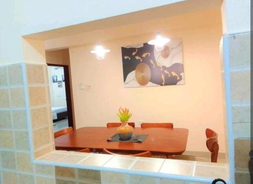 a dining room with a table and a mirror at MEDZAM HOMES BRILLIANT THREE BEDROOM ALL WITH OCEAN ViEW in Mombasa