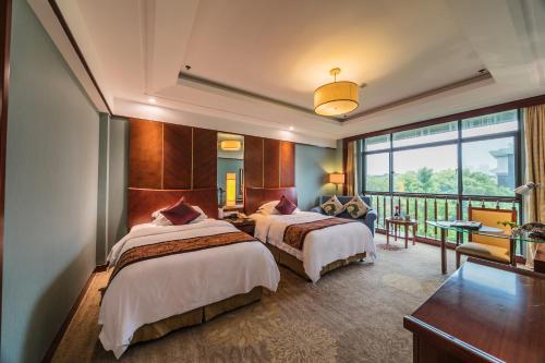 a hotel room with two beds and a balcony at Luoxingge Narada Hotel in Jiashan