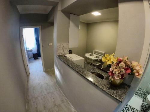 a kitchen with a sink and flowers on a counter at MirAlya Homes in Fethiye