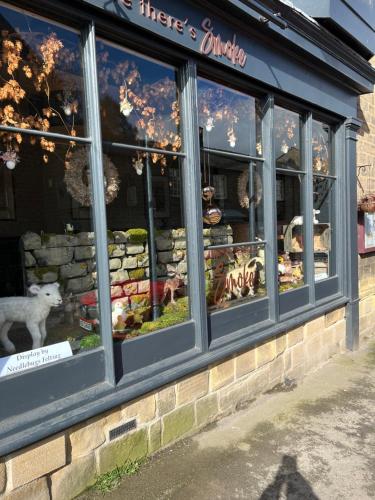a store window with a bunch of stuffed animals in it at Brewers Den in Masham